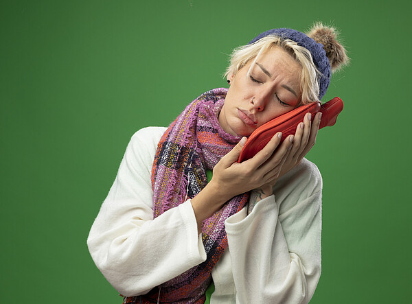 sick, unhealthy, woman, short, hair, warm, scarf, hat, feeling, unwell, holding, water, bottle, near, face, standing, over, green, background